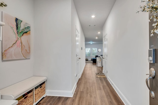 corridor with visible vents, baseboards, recessed lighting, and wood finished floors