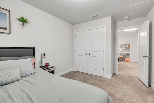 carpeted bedroom featuring a closet, visible vents, and baseboards
