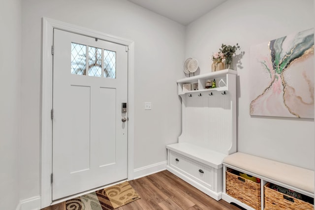 mudroom with wood finished floors and baseboards