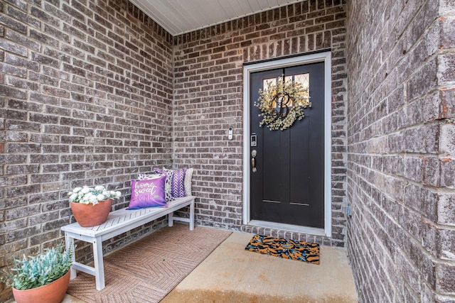 property entrance featuring brick siding