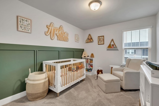 bedroom featuring carpet flooring and a crib