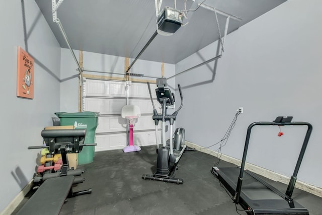 workout area with baseboards and a garage