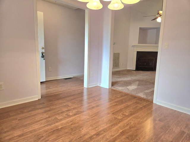 307 Parrish Cres, Mount Juliet, TN 37122 - unfurnished living room featuring a fireplace, a chandelier, wood finished floors, and ceiling fan