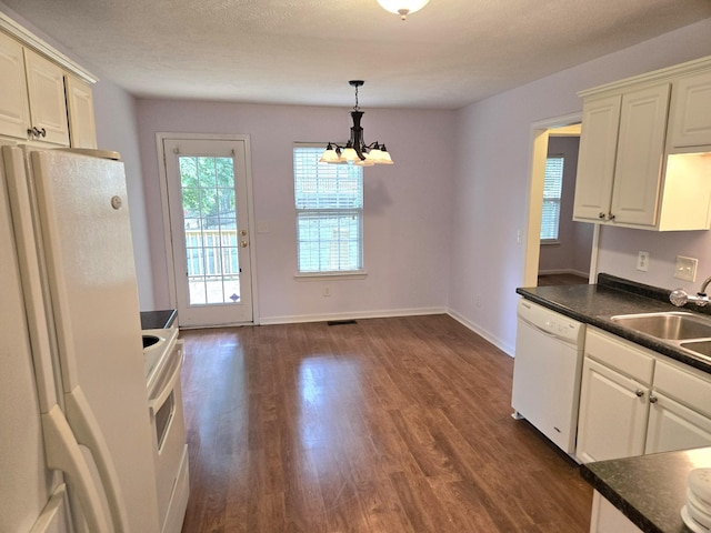 307 Parrish Cres, Mount Juliet, TN 37122 - kitchen featuring white appliances, dark countertops, dark wood-style floors, and a chandelier