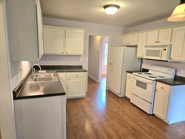 307 Parrish Cres, Mount Juliet, TN 37122 - kitchen with white appliances, white cabinetry, wood finished floors, dark countertops, and a textured ceiling