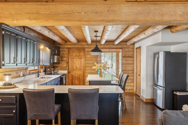 kitchen with rustic walls, wooden ceiling, dark wood finished floors, and stainless steel appliances