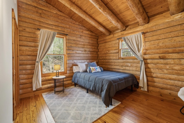 bedroom featuring hardwood / wood-style floors, wooden ceiling, vaulted ceiling with beams, and rustic walls