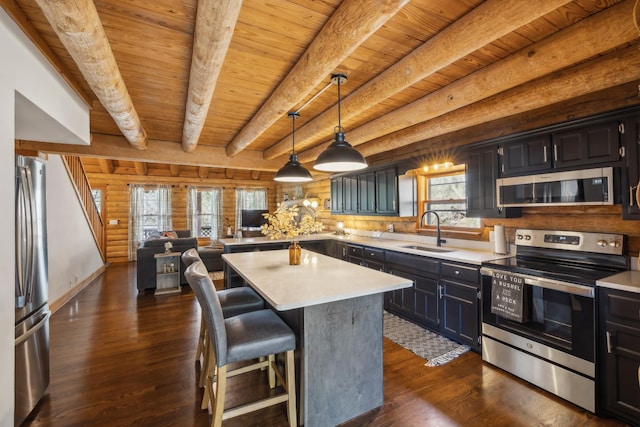 kitchen with a sink, light countertops, wood ceiling, stainless steel appliances, and dark wood-type flooring