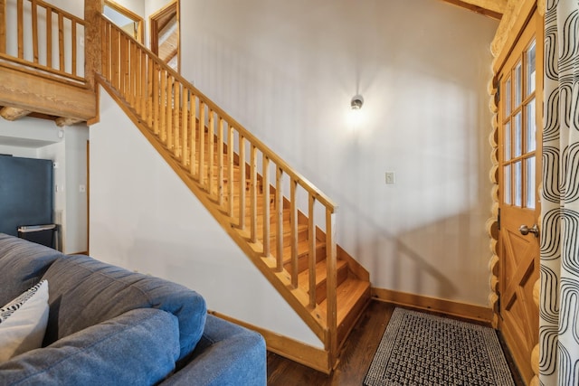 stairs featuring baseboards and wood finished floors