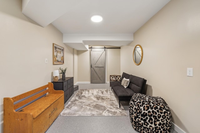 living area with baseboards and a barn door