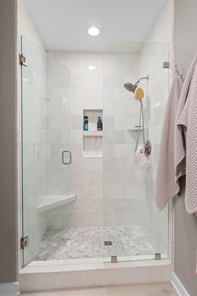 bathroom featuring baseboards and a stall shower