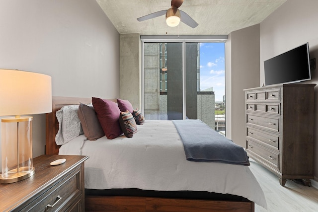 bedroom featuring light wood finished floors, multiple windows, access to exterior, and a ceiling fan