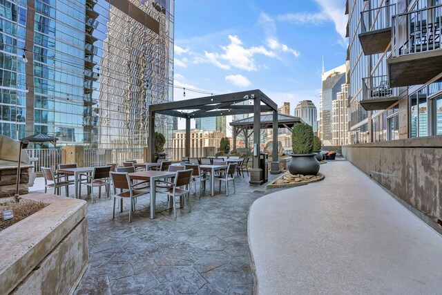 view of patio / terrace with outdoor dining space and a city view