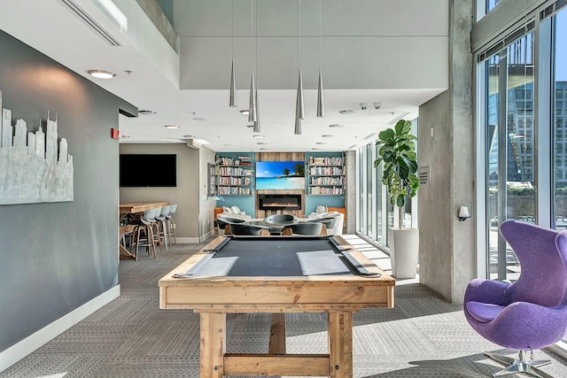 recreation room with carpet flooring, pool table, a glass covered fireplace, and baseboards