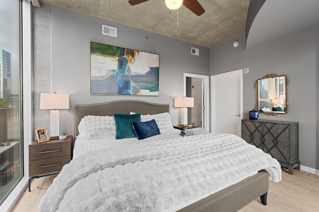 bedroom featuring visible vents, ceiling fan, and wood finished floors