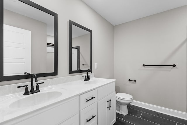 50 Gratton Ests, Clarksville, TN 37043 - bathroom featuring toilet, double vanity, baseboards, and tile patterned flooring