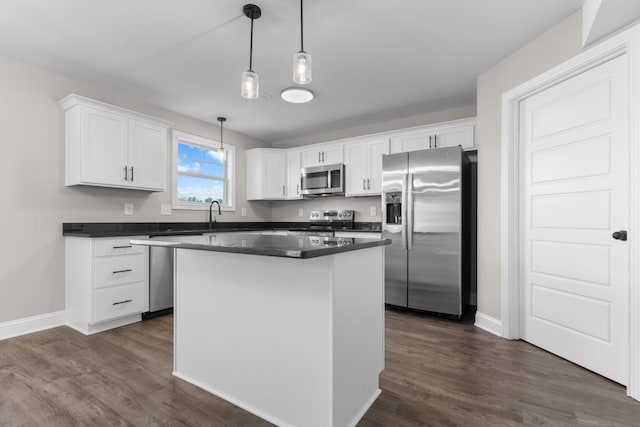50 Gratton Ests, Clarksville, TN 37043 - kitchen featuring appliances with stainless steel finishes, dark countertops, white cabinetry, and a center island