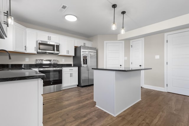 50 Gratton Ests, Clarksville, TN 37043 - kitchen featuring stainless steel appliances, dark countertops, dark wood-style floors, white cabinetry, and a sink