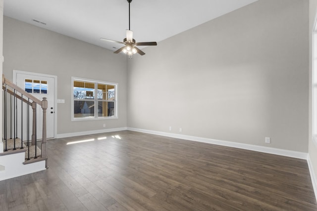 50 Gratton Ests, Clarksville, TN 37043 - unfurnished living room featuring stairway, dark wood-style floors, a ceiling fan, baseboards, and a towering ceiling