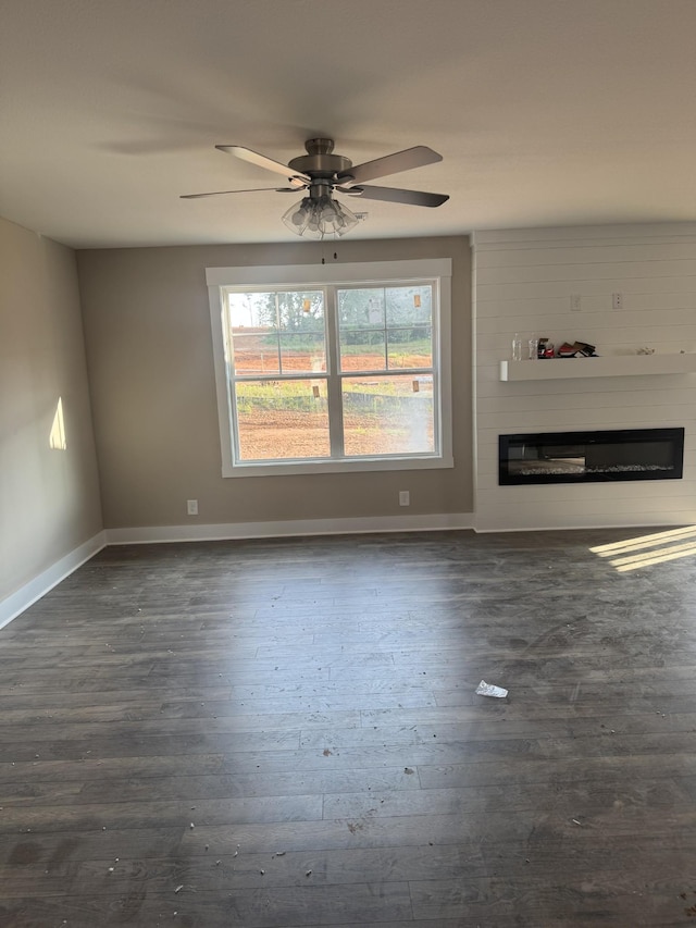 170 Cardinal Crk, Clarksville, TN 37040 - unfurnished living room with a glass covered fireplace, dark wood finished floors, baseboards, and a ceiling fan