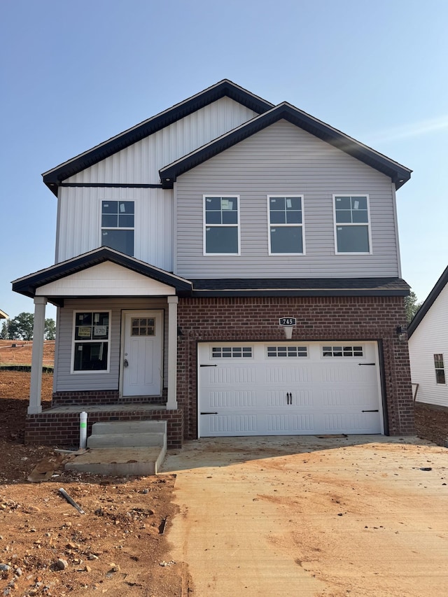 170 Cardinal Crk, Clarksville, TN 37040 - view of front of property with brick siding, an attached garage, a porch, and driveway