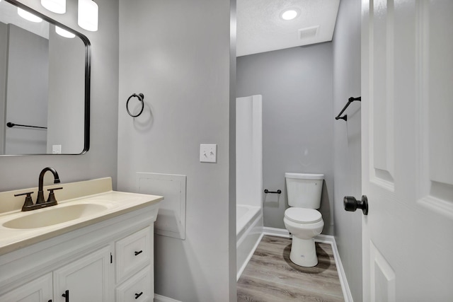 4817 Terragon Trl, Antioch, TN 37013 - bathroom featuring wood finished floors, visible vents, toilet, vanity, and baseboards