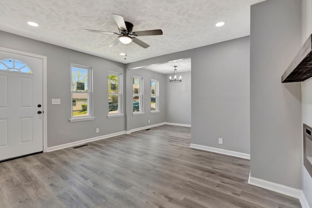 4817 Terragon Trl, Antioch, TN 37013 - entrance foyer with ceiling fan with notable chandelier, baseboards, visible vents, and a textured ceiling