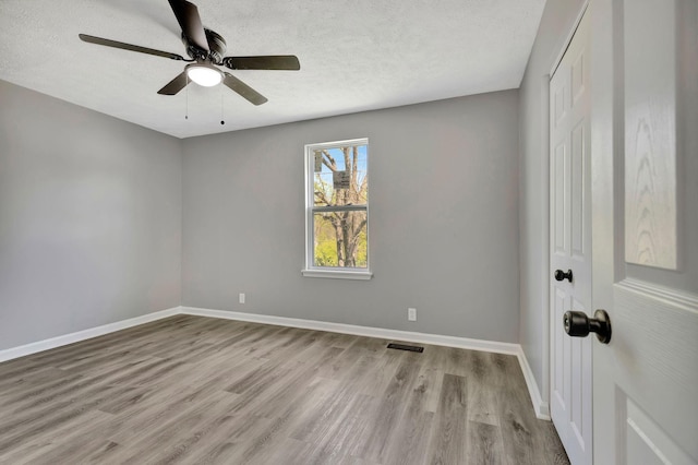 4817 Terragon Trl, Antioch, TN 37013 - unfurnished room featuring baseboards, wood finished floors, a textured ceiling, and ceiling fan