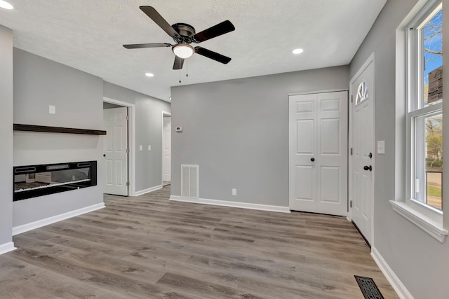 4817 Terragon Trl, Antioch, TN 37013 - unfurnished living room with recessed lighting, wood finished floors, visible vents, and a ceiling fan