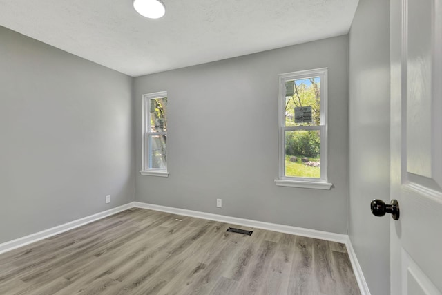 4817 Terragon Trl, Antioch, TN 37013 - spare room with plenty of natural light, visible vents, and wood finished floors