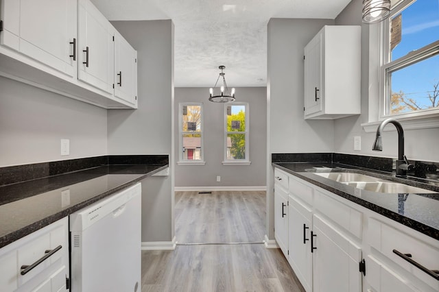 4817 Terragon Trl, Antioch, TN 37013 - kitchen with light wood finished floors, a wealth of natural light, dishwasher, and a sink
