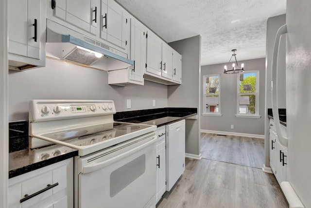 4817 Terragon Trl, Antioch, TN 37013 - kitchen with dark countertops, a textured ceiling, a chandelier, white appliances, and under cabinet range hood