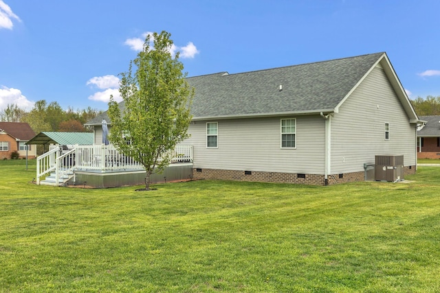 rear view of property featuring central AC unit, a shingled roof, a yard, crawl space, and a wooden deck