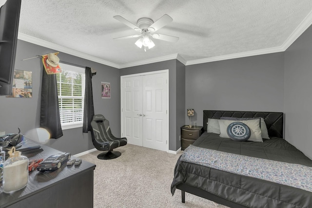 bedroom featuring a closet, ornamental molding, a textured ceiling, a ceiling fan, and carpet
