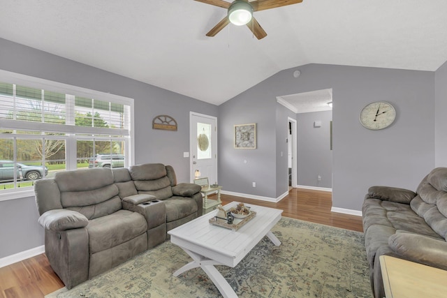 living area with wood finished floors, ceiling fan, baseboards, and vaulted ceiling