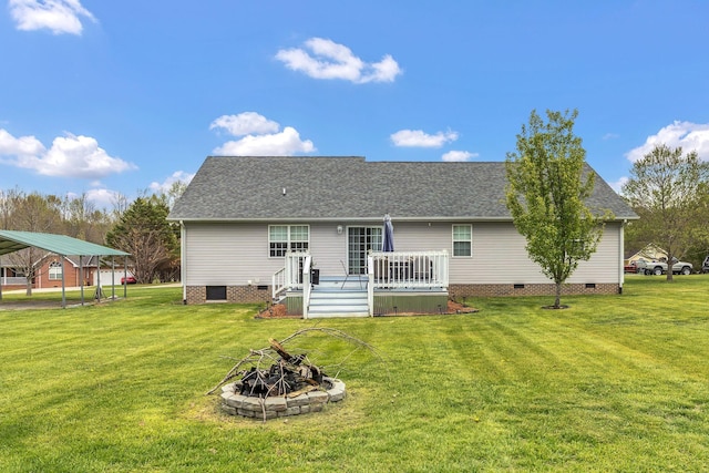 back of property featuring roof with shingles, crawl space, a wooden deck, and a lawn