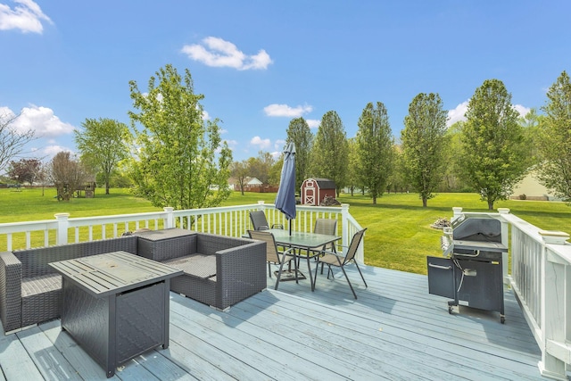 wooden terrace with outdoor lounge area, a grill, an outbuilding, a yard, and a storage unit