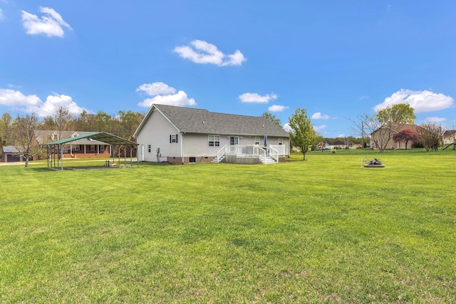 rear view of house featuring crawl space, a yard, and a shingled roof