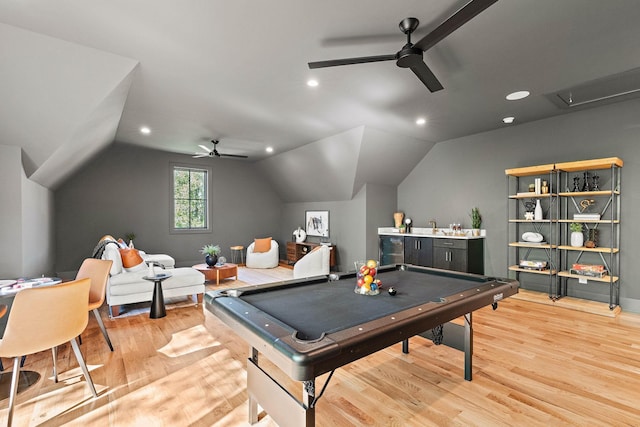 game room with attic access, light wood-style flooring, and ceiling fan