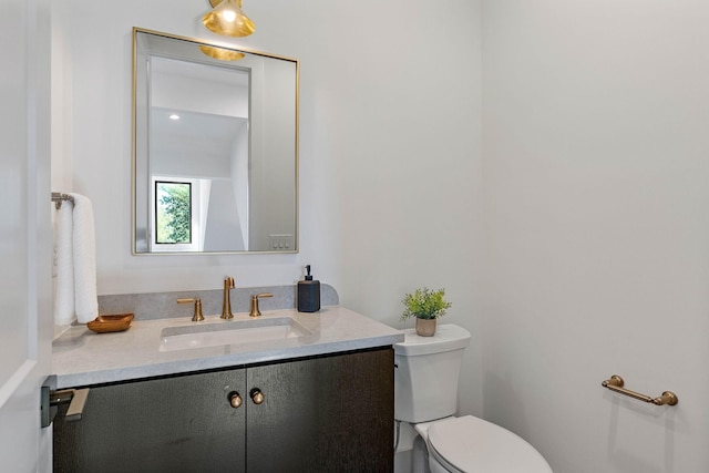 bathroom with toilet and vanity
