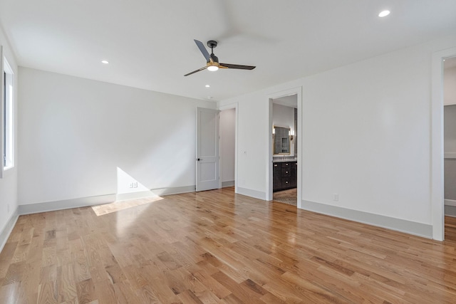unfurnished bedroom featuring connected bathroom, baseboards, recessed lighting, and light wood-style flooring
