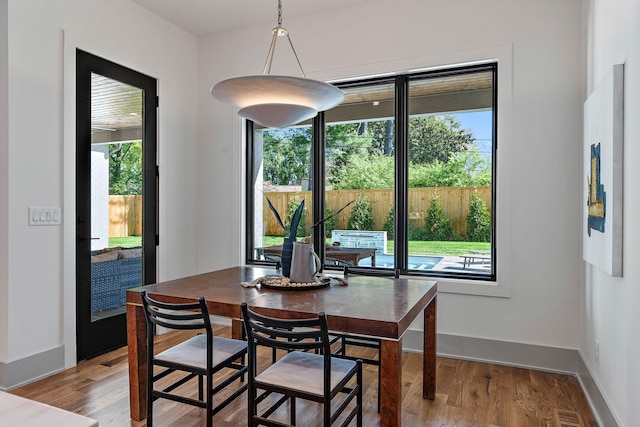 dining space with baseboards, light wood-style floors, and visible vents