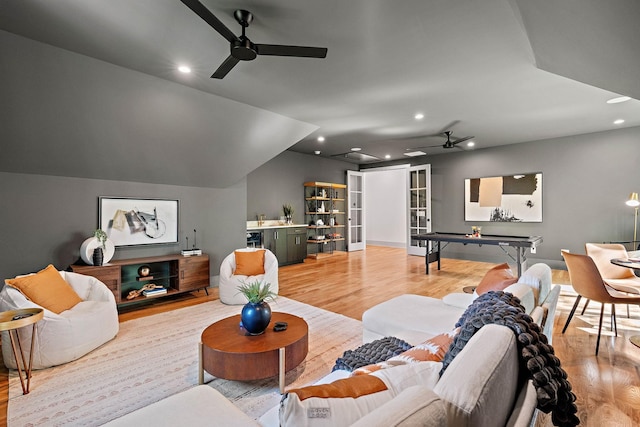 living area featuring light wood finished floors and a ceiling fan