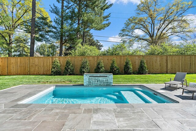 view of swimming pool with a patio area, a lawn, and a fenced backyard