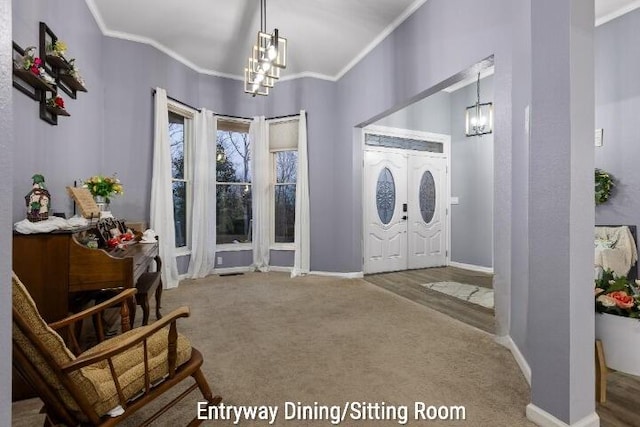foyer entrance featuring carpet flooring, an inviting chandelier, and ornamental molding