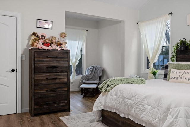 bedroom with baseboards and dark wood-style floors