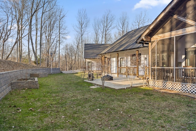 view of yard featuring a patio and a sunroom