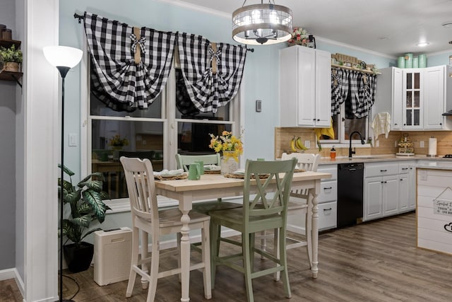 kitchen with ornamental molding, white cabinets, dishwasher, a sink, and light countertops