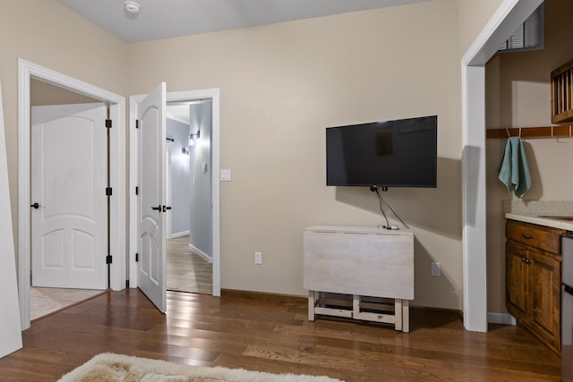 bedroom with baseboards and wood finished floors