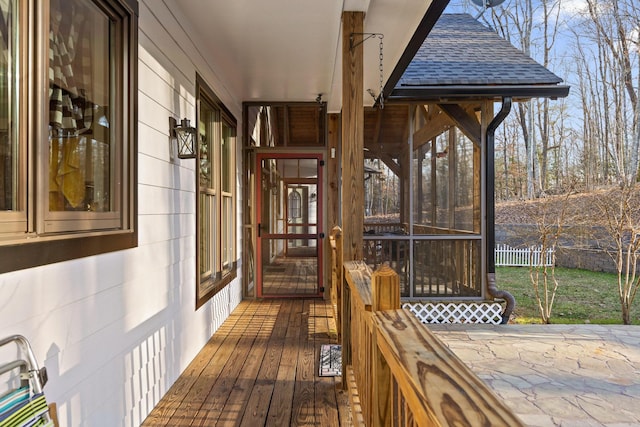 deck featuring fence and a sunroom